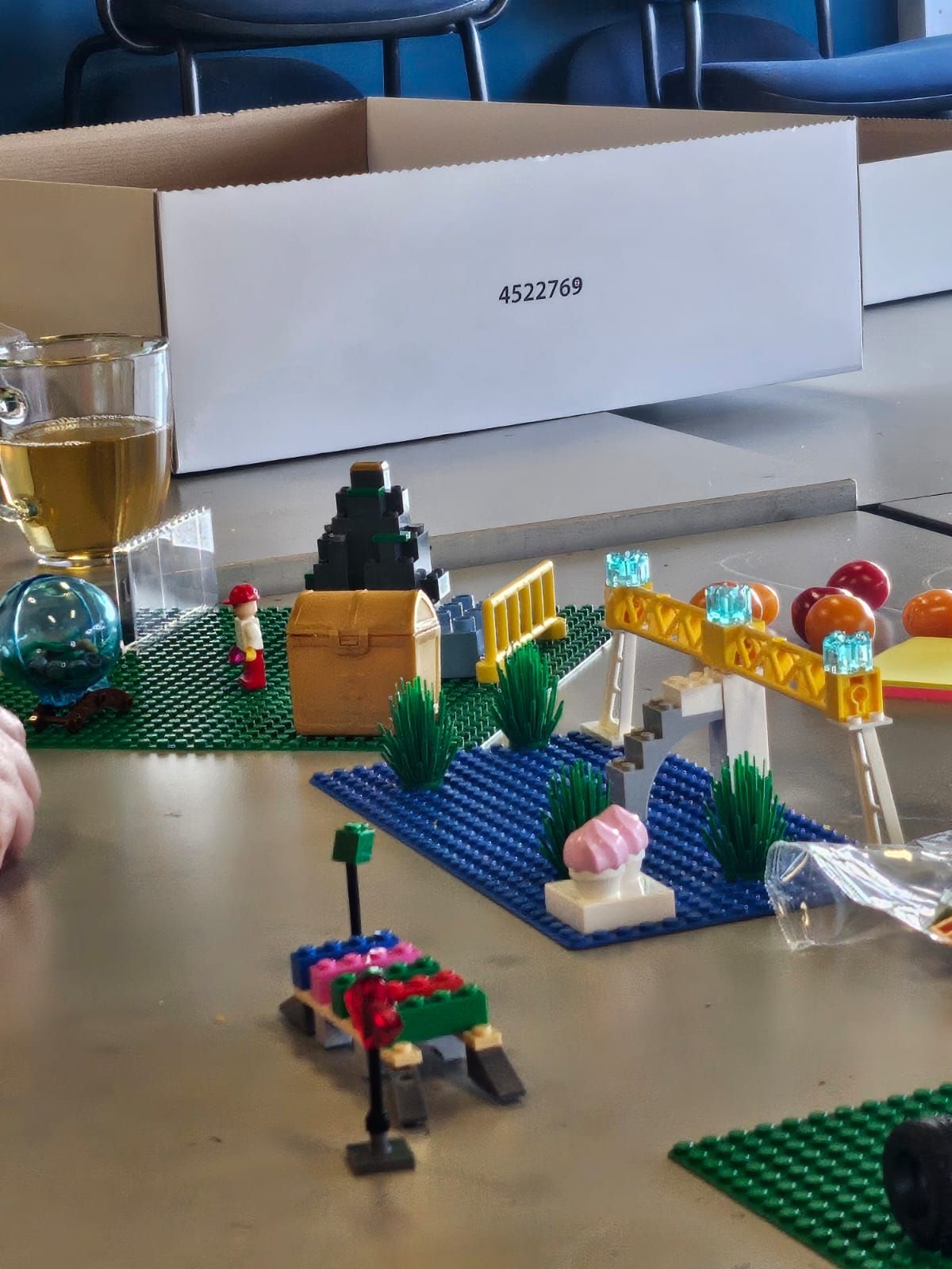 A detailed model built from LEGO elements on a workshop table.