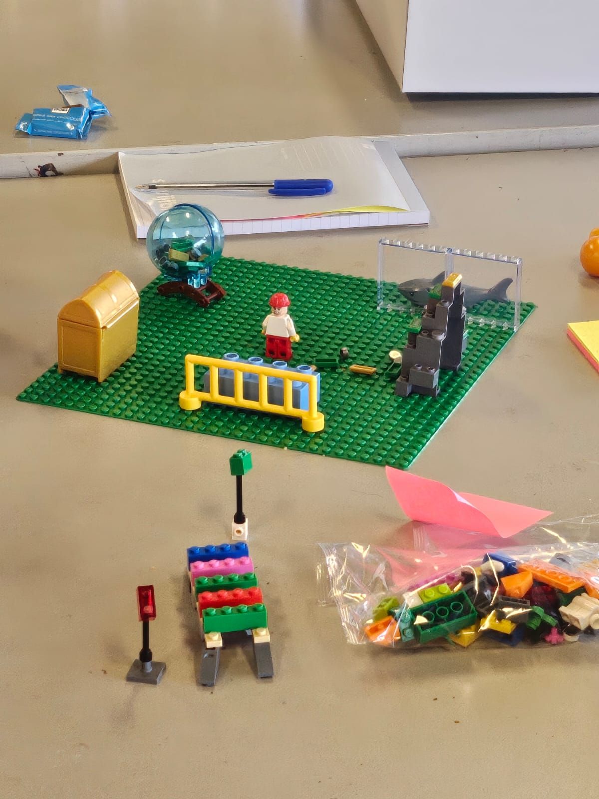 A LEGO model with a figure, a chest and a transparent structure.